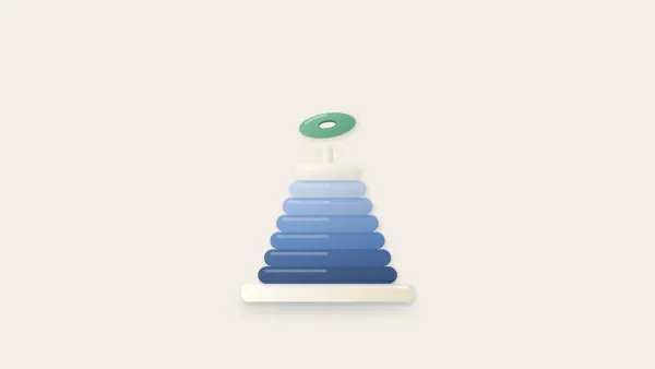 Clay stacking ring tower with its smallest top ring hovering above, not yet placed
